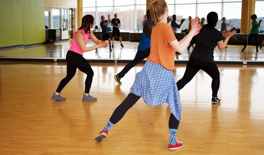 A group of people participating in low-impact exercises in a fitness class.